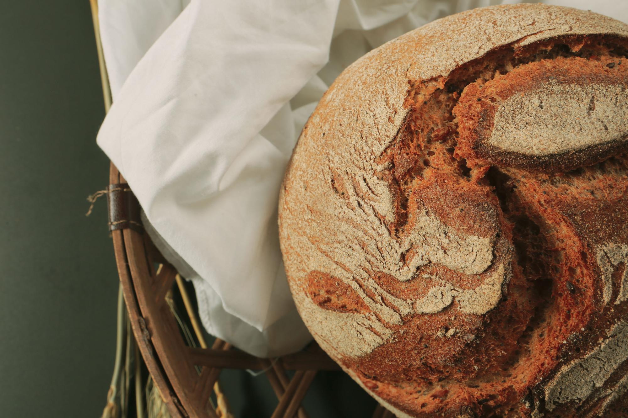 close-up of artisanal loaves and seasonal produce on paper